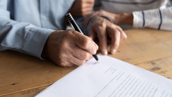 man signing a legal document